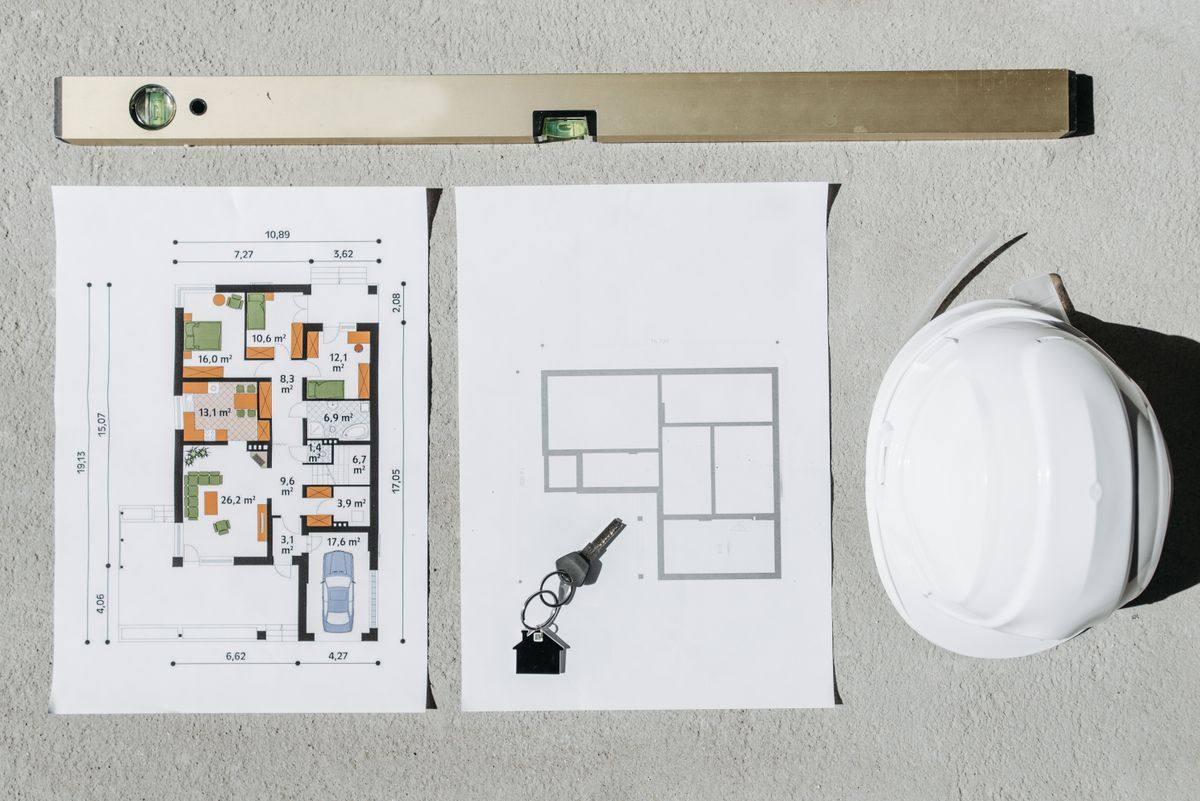 Renovation planning: blueprints, level and hard hat